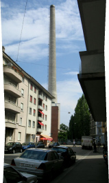 Chemie-Terror 40 und 41: Mattenstrasse,
                        Sicht auf den grauen Kamin der Chemie-Giftfabrik
                        Syngenta, Panoramafoto