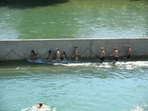 Zurich at Letten Viaduct, people walking at
                        a Limmat river wall