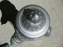 The knob of the fire hydrant, like a jelly
                        bag cap