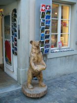 Zurich, Schipfe, shop
                        "swisssouvenir" with a statue of a
                        bear carved in wood holding a plate