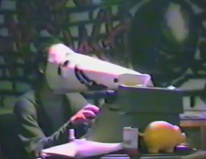 Squatting at Baden
                            Street N 2, a person with bird mask at a
                            type writer