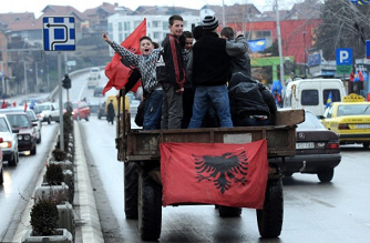 Kosovo Albanians on a horse carriage
                            without protection