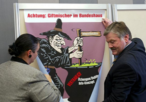 Poster of
                        Nazi SVP in 2004 against the vote about Schengen
                        and Dublin agreement. National Government
                        Building is depicted as a location of poison
                        production, presented here by SVP racist Hans
                        Fehr