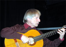 Dimitri with guitar playing a
                          song without mask.