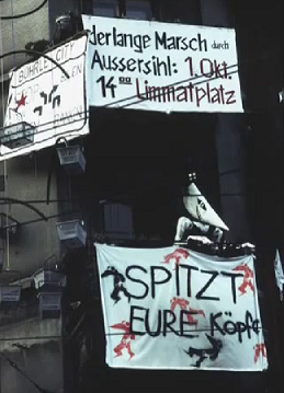 Squatting of Baden Street N� 2, banner
                          announcing a demonstration "Long March
                          passing Aussersihl District", October
                          1983