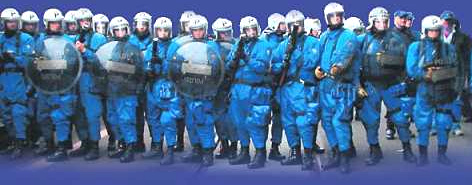 Swiss bully police (Nazis in Blue)
                                in standby position in the train station
                                of Altstetten District in Zurich,
                                December 5, 2004