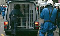 Swiss bully police (Nazis in Blue)
                                transporting 427 soccer fans from Basel
                                in barred vans to the
                                "Barracks", Zurich police
                                center near the central station,
                                December 5, 2004