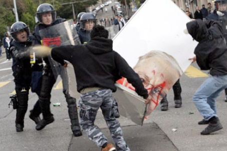 Demonstration in Lausanne 2007,
                                    Demonstranten mit einem
                                    Blocher-Plakat werden von der
                                    Polizei angegriffen